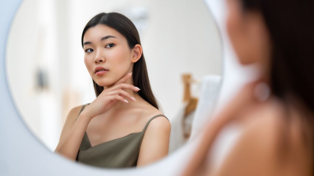 woman looking at mirror